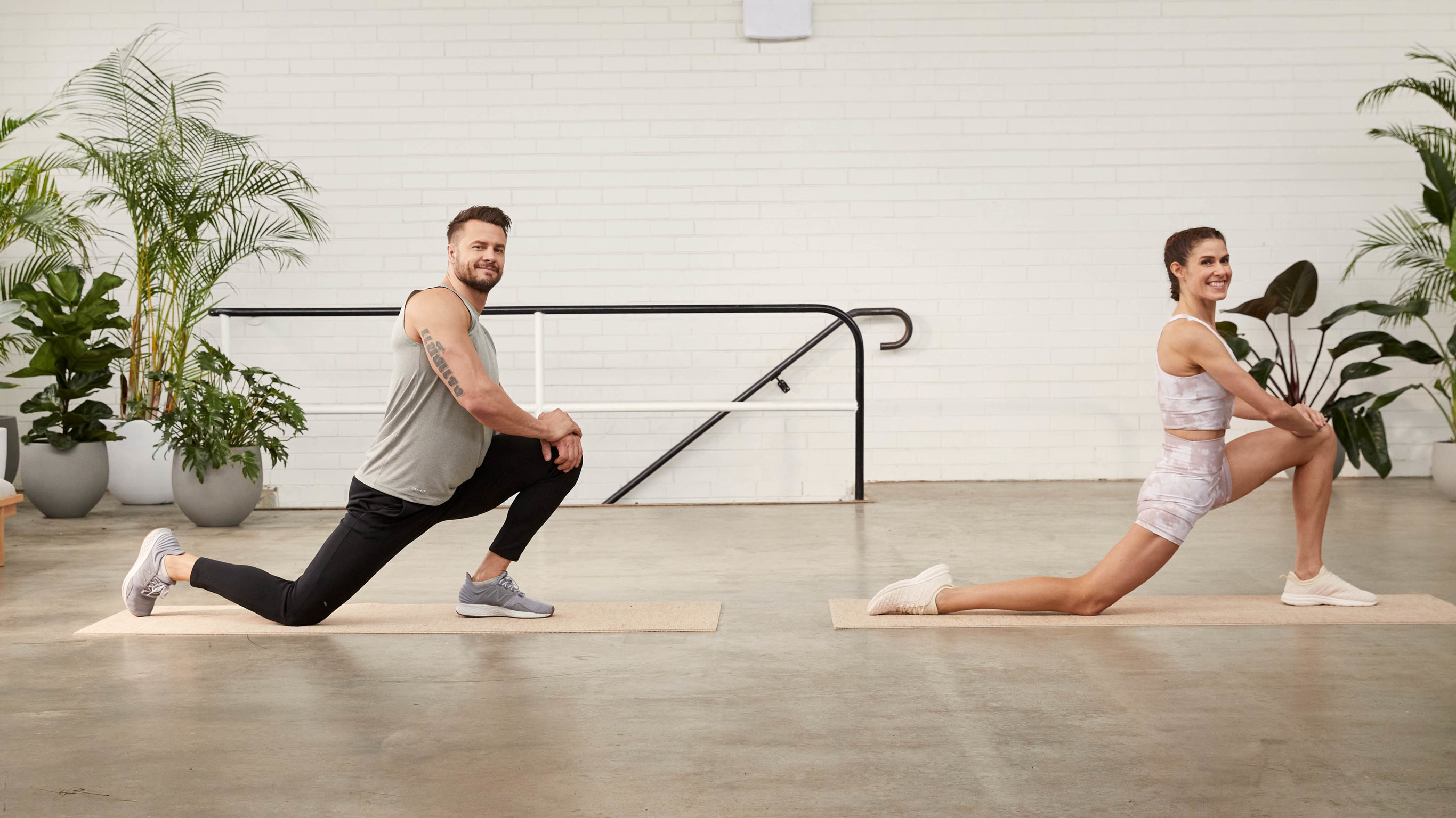 Bobby Holland Hanton and Sylvia Roberts perform a hip flexor stretch.