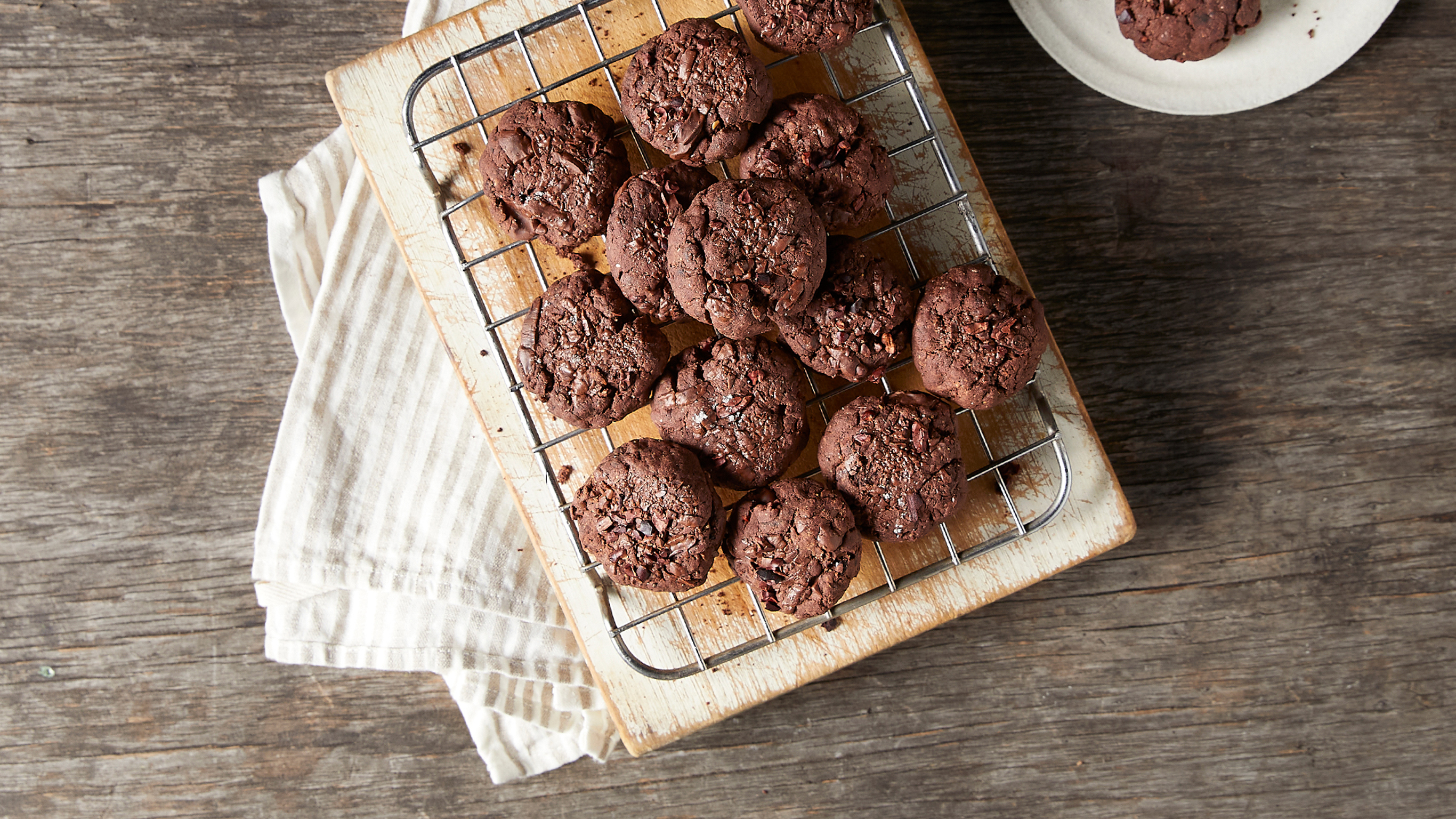 A pile of Triple Chocolate Cookies from the Centr menu sit on a cooling rack, ready for eating.
