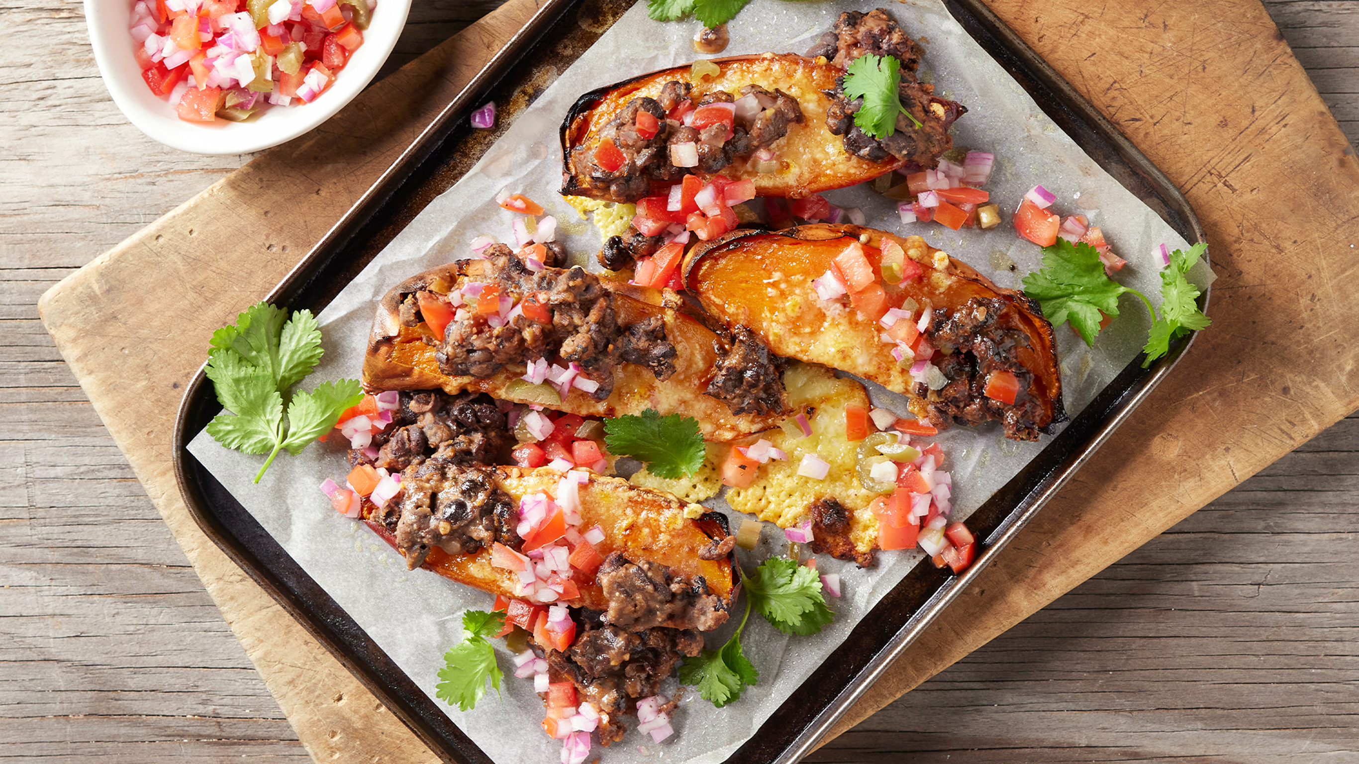 A tray of Dan's Baked Sweet Potatoes from the Centr menu is ready for serving.