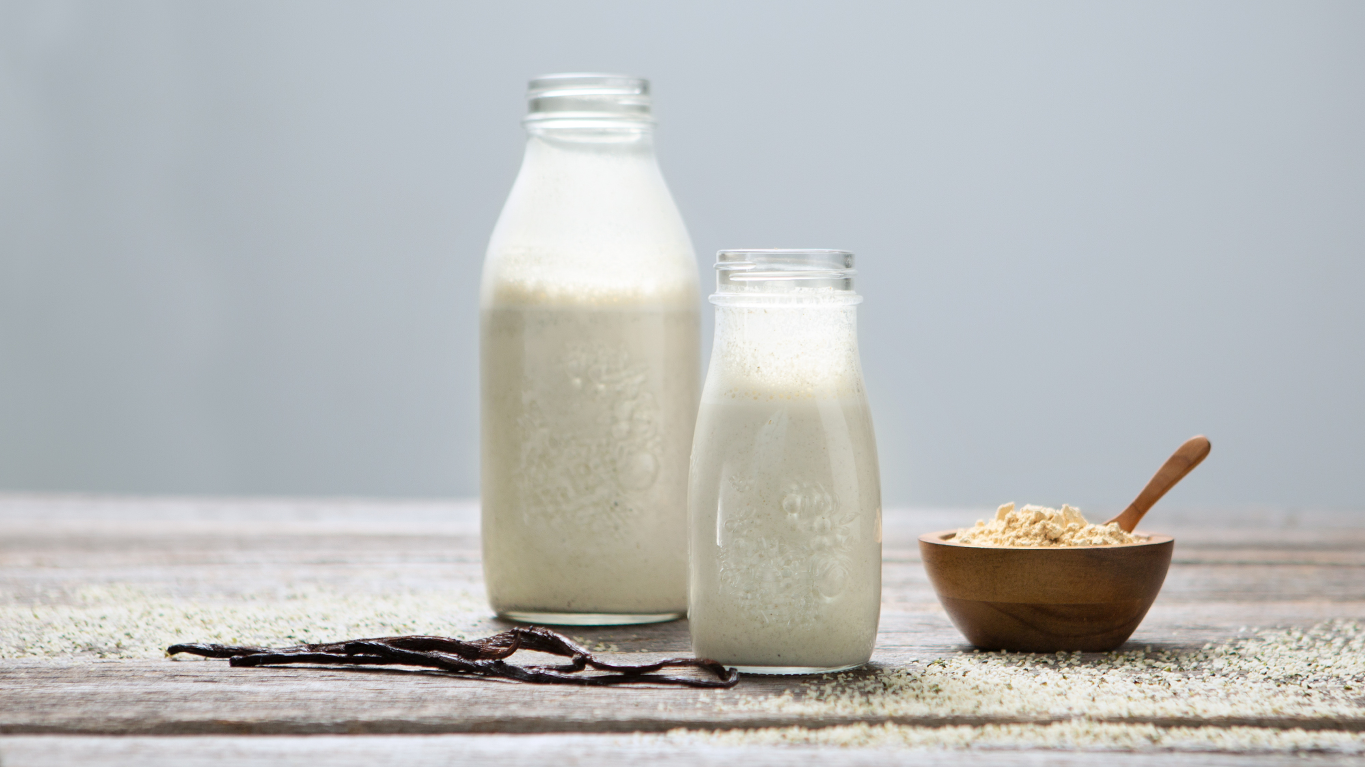 Hemp seed milk displayed in glass bottles.