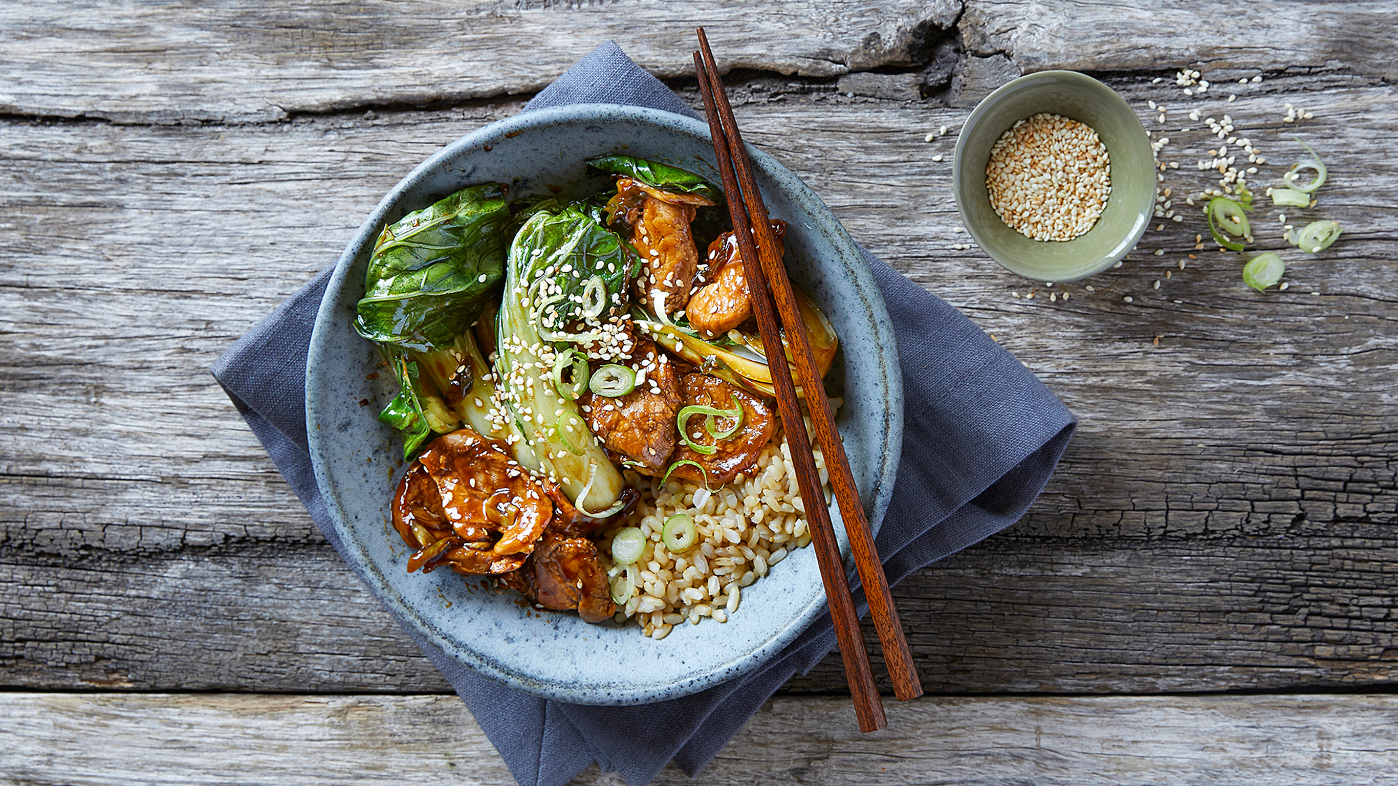 A bowl of honey pork with bok choy.